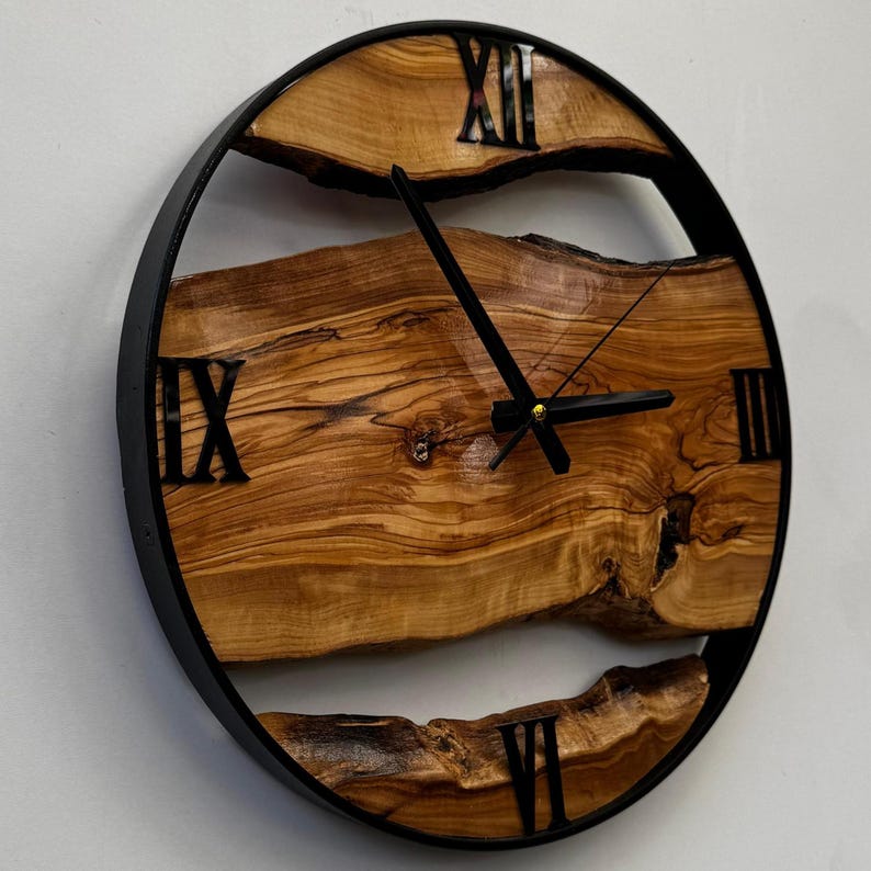 Handcrafted olive wood wall clock with unique grain and smooth finish.