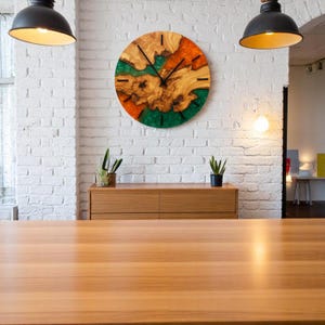 Handcrafted wall clock with natural wood and bright epoxy resin design.
