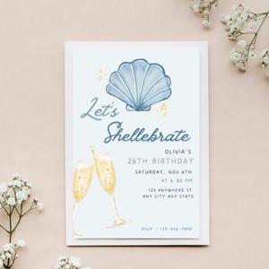 May include: A blue and white seashell illustration with gold stars on a light blue background. The text "Let's Shellebrate" is written in a cursive font. The invitation is for Olivia's 26th birthday party on Saturday, November 6th at 6:00 PM. The address is 123 Anywhere St, Any City Any State. The RSVP number is 123-456-7890.