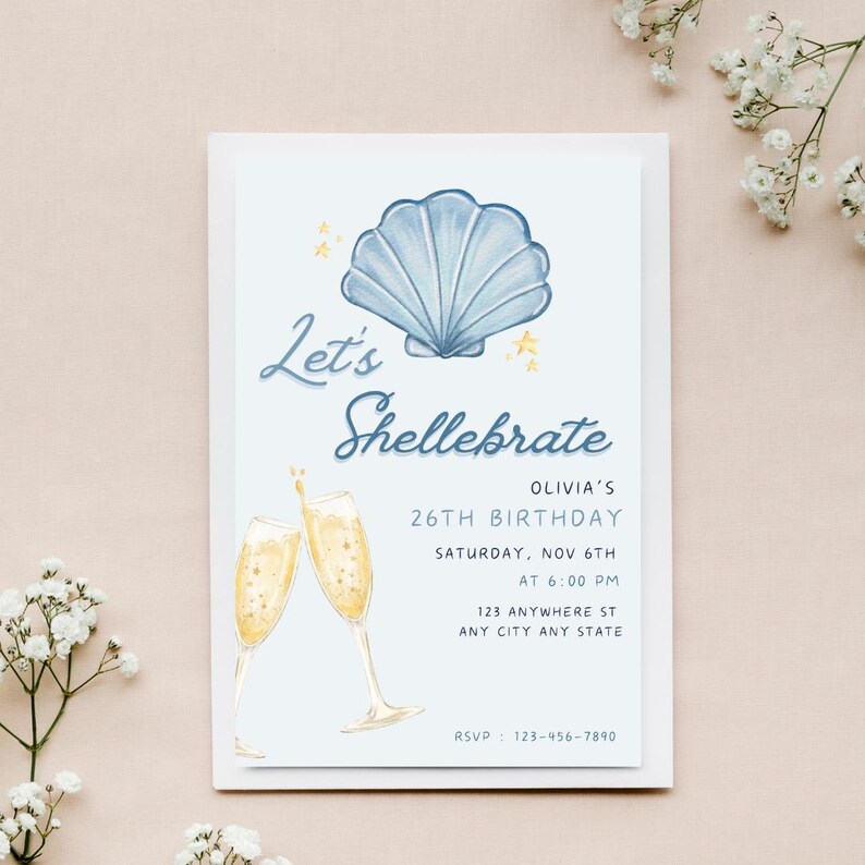 May include: A blue and white seashell illustration with gold stars on a light blue background. The text "Let's Shellebrate" is written in a cursive font. The invitation is for Olivia's 26th birthday party on Saturday, November 6th at 6:00 PM. The address is 123 Anywhere St, Any City Any State. The RSVP number is 123-456-7890.