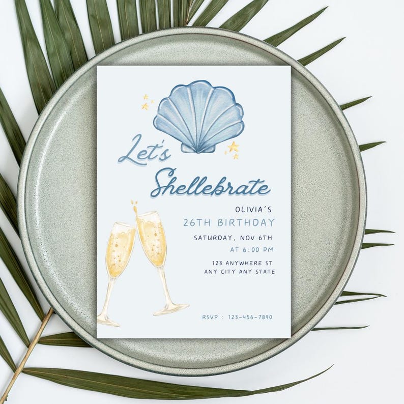 May include: A blue and white seashell illustration with gold stars on a light blue background. The text "Let's Shellebrate" is written in a whimsical font. The invitation is for Olivia's 26th birthday party on Saturday, November 6th at 6:00 PM. The address is 123 Anywhere St, Any City, Any State. The RSVP number is 123-456-7890.