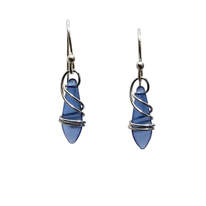 Ear wires are sterling silver, handmade with deep blue satin finish dagger glass beads. Length is 3/4 inches. Delightedly hand wrapped in sterling silver. Gift box included. Looks like blue sea glass.