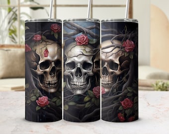 May include: Three stainless steel tumblers with a black background and a design of three skulls with roses and vines. The skulls are white with black eyes and a dark gray background.