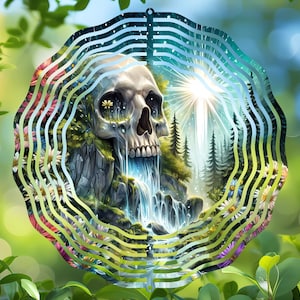 May include: A metal wind spinner with a colorful design featuring a skull, a waterfall, and a forest. The skull is white with black eyes and a waterfall flows from its mouth. The background is a green forest with a bright light shining through the trees.