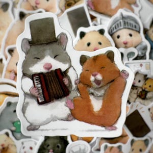 May include: Two cartoon hamsters, one wearing a top hat and playing an accordion, the other with its mouth open, are depicted on a white sticker. The sticker is surrounded by other stickers featuring various cartoon hamsters.