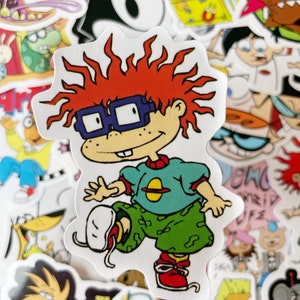 May include: A sticker featuring a cartoon character with red hair, wearing blue glasses, a green shirt with a yellow planet, and green camouflage pants. The character is running and kicking their leg up.