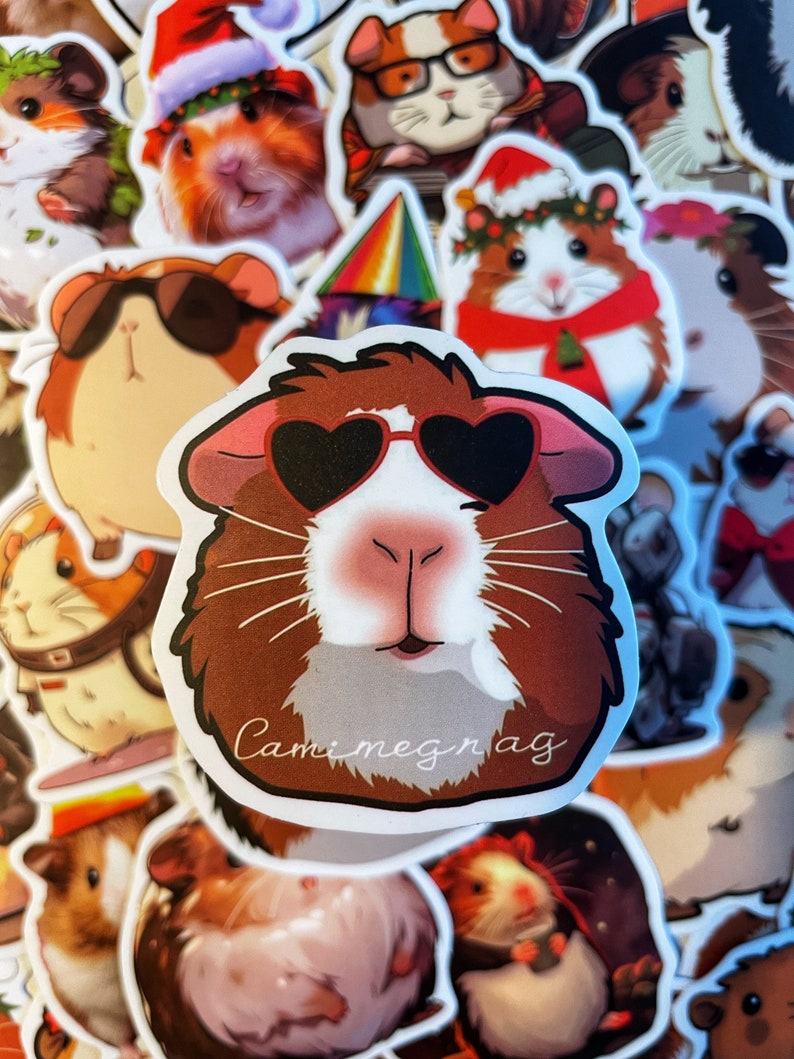 May include: A collection of colorful stickers featuring cartoon guinea pigs wearing various accessories, including sunglasses, hats, and scarves. The stickers are printed with the text "Camimegnag".