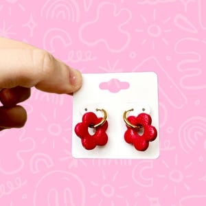 Creole earrings with red flower pendants