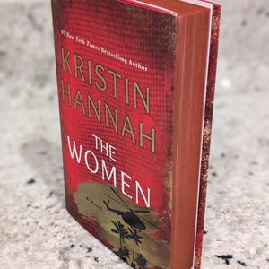 The Women by Kristin Hannah with custom red and gold sprayed edges, special edition books, historical fiction, book lover gifts, bestseller