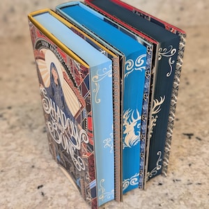 Shadow and Bone Trilogy by Leigh Bardugo with custom edges and special dust jackets, special edition books, sprayed stenciled edges, fantasy
