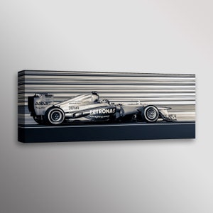 May include: A silver Formula One race car speeding down a track with a blurred background. The car has the Petronas logo and the words "reimagining energy" on the side. The car also has the logos for Aabar, Mercedes-Benz, and Syntium.