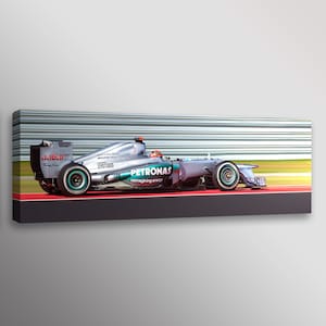 May include: A silver Formula 1 race car with green and black accents. The car is on a racetrack with a red and green surface. The car has the Petronas logo and the text "reimagining energy" on the side. The car has the number 6 on the side.