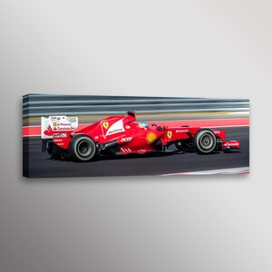 May include: A red Ferrari Formula One race car speeding around a track. The car has the logos of sponsors like Santander, Acer, and Shell.