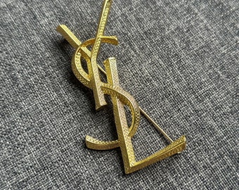 YSL VTG Yves Saint Laurent Vintage gouden broche 7 cm metaalstaal logo monogram accessoire sieraden