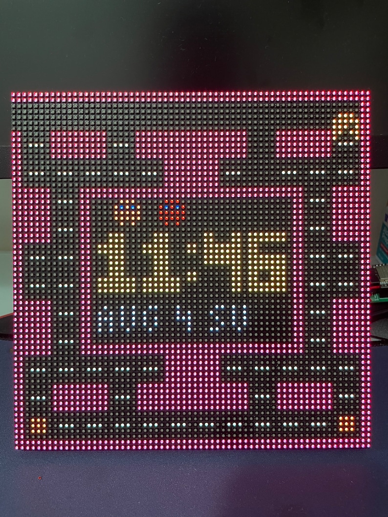 May include: A black LED display with a pink border shows the time 11:46 and the date AUG 4, 51. The display has a pixelated appearance.