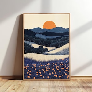 May include: Framed landscape art print featuring a stylized sunset over rolling hills and a field of orange flowers. The artwork uses a palette of blues, beige, and orange, creating a serene and natural scene. The print is displayed in a wooden frame.
