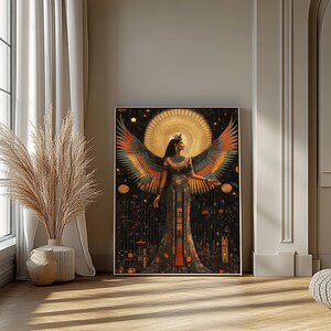 May include: A framed art print depicting a woman with large, colourful wings, set against a dark background with a golden halo. The woman wears an ornate dress and a crown. The artwork evokes a sense of ancient mythology and is rich in detail.