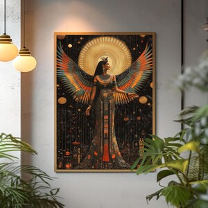 May include: A framed art print depicting a woman with large, colourful wings. The artwork shows a figure in an ornate gown, set against a dark background with a golden halo. The colour palette includes gold, orange, and black.