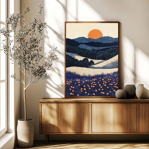 May include: A framed landscape art print featuring a stylized sunset over rolling hills and a field of orange flowers. The artwork has a warm color palette with shades of blue, orange, and cream. The frame is a warm brown color.