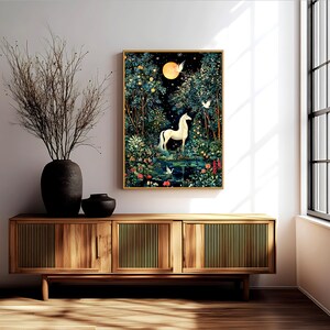May include: A framed vertical wall art print depicting a white horse standing in a lush, dark forest at night under a glowing yellow moon. The scene includes a small pond, white birds, and colorful flowers, all rendered in a detailed, illustrative style.