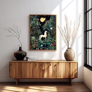 May include: A framed rectangular wall art print featuring a white horse standing in a dark, lush forest at night. The scene includes a bright yellow moon, glowing stars, and white birds flying among dense green trees, colorful flowers, and a pond.