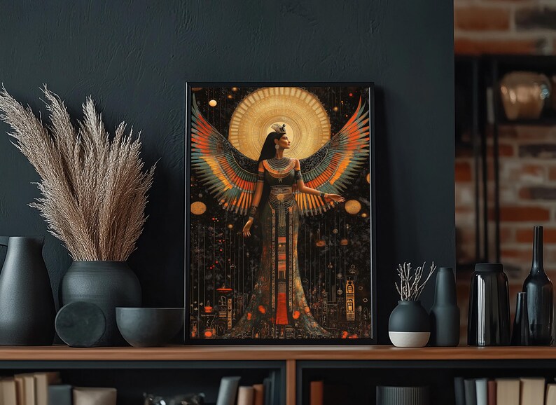 May include: Framed art print depicting a woman with large, colourful wings, set against a golden sunburst. The artwork has an Egyptian theme with intricate details and a dark, celestial backdrop. The print is displayed on a wooden shelf, with other decorative items.