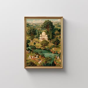 May include: A framed print depicting a serene landscape with a white domed building, lush greenery, and a flowing river. The artwork features figures in white clothing, suggesting a picnic or gathering. The frame is gold-colored, adding a touch of elegance.