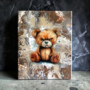 May include: A rectangular canvas painting featuring a brown teddy bear with a grumpy facial expression. The bear is centered against an abstract background of swirling metallic gold, bronze, white, and dark brown paint with a marbled texture.