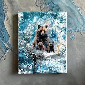 May include: A canvas print featuring a family of bears. The artwork depicts a mother bear with two cubs, set against a backdrop of swirling blue and white abstract patterns. The bears are rendered in shades of brown and black.