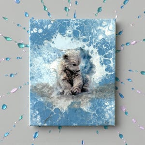 May include: A canvas art piece featuring a polar bear cub. The artwork has a blue and white abstract background with a textured appearance. The cub is depicted in shades of gray and white, sitting and looking down. Decorative paint splatters surround the canvas.