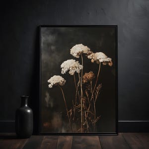 May include: A framed print of a botanical illustration featuring dried white flowers with brown stems against a dark background.