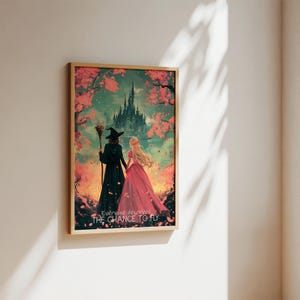 May include: A framed illustration of two women walking away from a dark castle. The woman in the front is wearing a pink dress and the woman in the back is wearing a black dress and a witch's hat. The background is a pink and green landscape with a quote that reads "Everyone deserves the chance to fly."