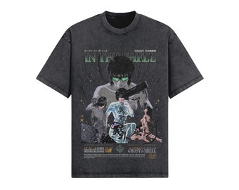 May include: A black t-shirt with a vintage-style graphic of characters from the anime "Ghost in the Shell". The graphic features the text "Ghost in the Shell" and "GHOSTASHELL" in Japanese and English.