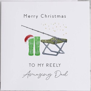 May include: A Christmas card with a green fishing boot wearing a Santa hat, a fishing rod, a folding chair, and the text "Merry Christmas to my Reely Amazing Dad".
