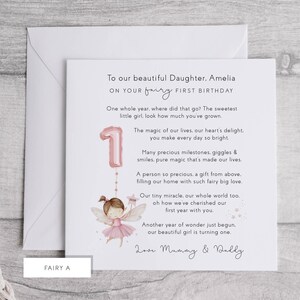 May include: A birthday card with a fairy theme. The card reads "To our beautiful Daughter, Amelia, on your fairy first birthday." It features a pink number one balloon and a fairy illustration. The card is inside a white envelope.
