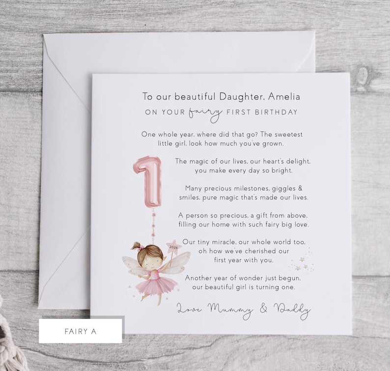 May include: A birthday card with a fairy theme. The card reads "To our beautiful Daughter, Amelia, on your fairy first birthday." It features a pink number one balloon and a fairy illustration. The card is inside a white envelope.