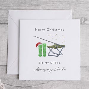 May include: A white Christmas card with a green fishing boot, a fishing rod, and a folding chair. The card says "Merry Christmas to my Reely Amazing Uncle".