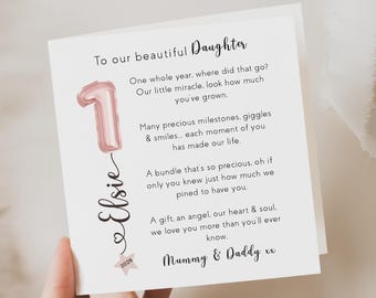 May include: A white greeting card with the text "To our beautiful Daughter" and a pink number 1 balloon illustration. The card includes the name "Elsie" and a message from "Mummy & Daddy."