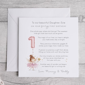 May include: A first birthday card for a daughter, featuring a pink number one balloon and a fairy illustration. The card includes the text: "To our beautiful Daughter, Evie, on your fairy first birthday."