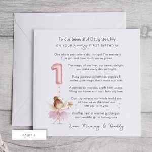 May include: A first birthday card with a fairy theme. The card features a pink number one balloon and a fairy illustration. The text reads "To our beautiful Daughter, Ivy, on your fairy first birthday."