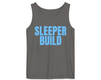May include: A dark grey sleeveless tank top featuring the text "SLEEPER BUILD" printed in a bold, light blue sans-serif font across the centre of the chest. The garment has a scoop neckline and wide shoulder straps, presented against a plain background.