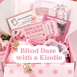 May include: A pink gift box with the text "Blind Date with a Kindle" contains a variety of items. Inside are pink paper, a ticket that says "Romance Readers Book Club", and other pink and white items. A gold tassel hangs from the box.