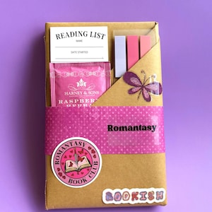 May include: A brown paper-wrapped gift box with a pink polka-dot band labeled "Romantasy." It contains a reading list, tea, and sticky notes. A butterfly sticker and a "Romantasy Book Club" sticker are also visible. The word "BOOKISH" is also visible.