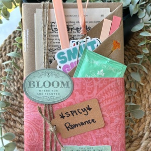 Blind Date with a Book is an exciting gift for book lovers! This mystery book package includes a handpicked book in genres like romantasy, paranormal, or thriller, all wrapped in clues. It comes with herbal tea, bookish stickers, annotation tabs, highlighter, book tracker, and a library-style reading list. Great for booktok, book clubs, dark romance fans, spicy reads, and anyone who loves surprises and reading adventures.