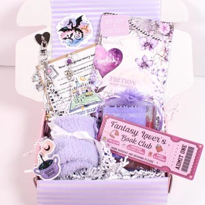 Blind Date with a Kindle mystery book box styled for booktok readers featuring kindle insert for clear case, cute kindle charm keychain, kindle dust plug charm, and decorative kindle stickers. Includes cozy reading items and aesthetic kindle accessories perfect for customizing a kindle paperwhite, kindle oasis, kindle scribe, or ereader case with personalized kindle decorations and booklover gifts.