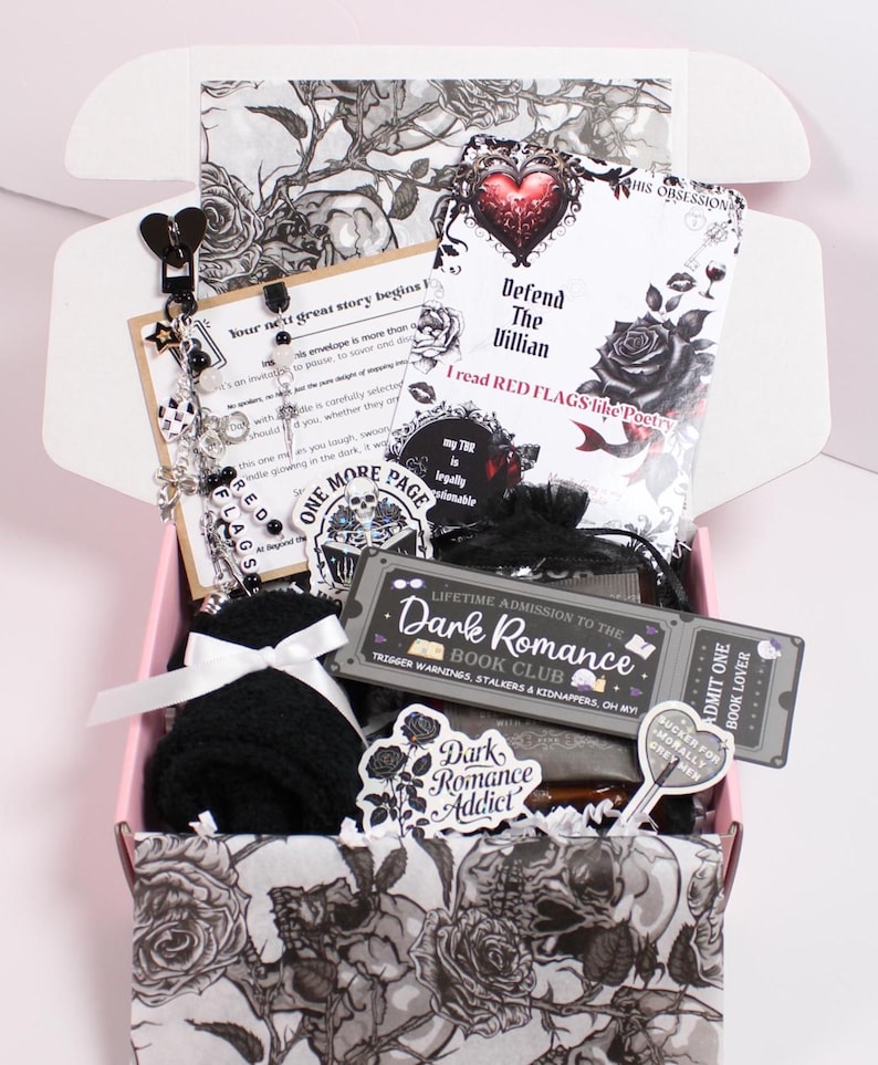 Blind Date with a Kindle gift set styled with cocoa, tea, cozy socks, themed bookmark, drink coaster, and sweet treat beside a kindle paperwhite. Includes kindle insert for clear case, kindle charm keychain, and dust plug charm. Perfect for readers decorating their kindle case, kindle sleeve, or ereader case with kindle stickers, kindle decorations, and aesthetic kindle accessories designed for cozy reading nights.