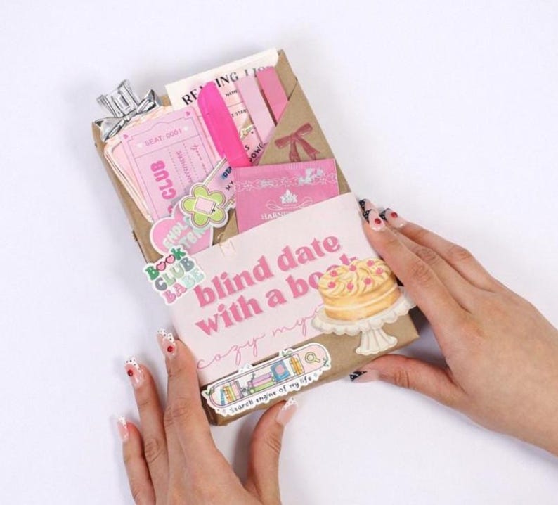 Kindle mystery box displayed as blind date with an ebook and blind date with a book kindle concept, featuring digital book bundle presentation, book gift box styling, bookish bundles arrangement, and reader gifts appeal for modern book lovers.