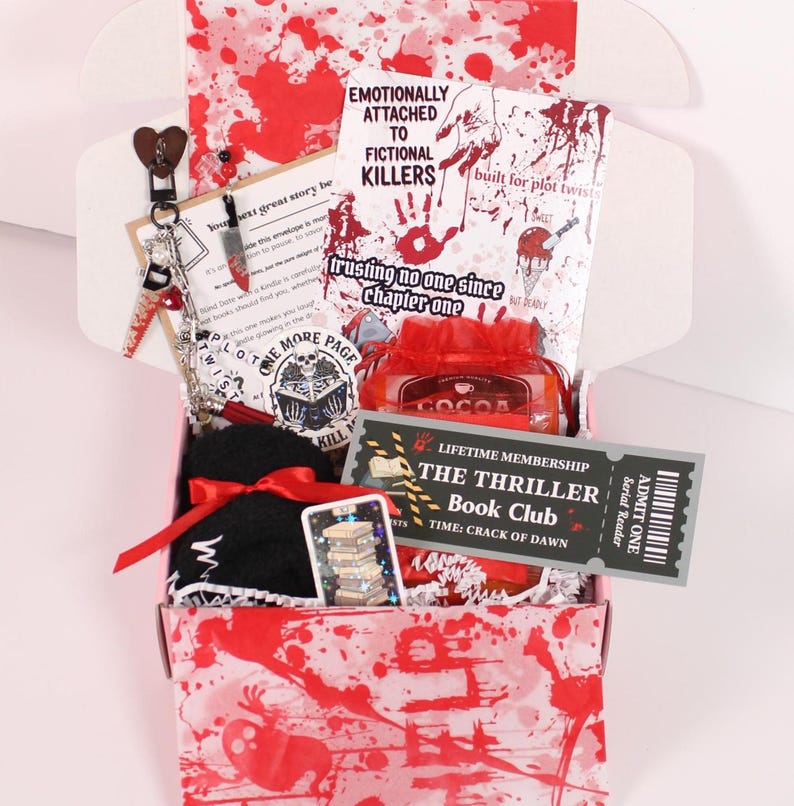 Blind Date with a Kindle mystery box for book lovers featuring a kindle insert for clear case, kindle charms, kindle dust plug charm, charm keychain, cozy socks, bookish stickers, sweet treat, and hot cocoa arranged as a cozy kindle accessories gift set. Perfect for decorating a kindle paperwhite or ereader case with cute kindle decorations, kindle stickers, and aesthetic kindle accessories that transform your reading night into a relaxing booklover experience.