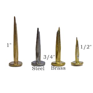 May include: Three upholstery tacks in different sizes: 1 inch, 3/4 inch, and 1/2 inch. The tacks are made of steel and brass.