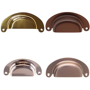 May include: Four cabinet pulls in different finishes: brass, oil rubbed bronze, nickel, and satin nickel. Each pull is a half-circle shape with a rounded edge.